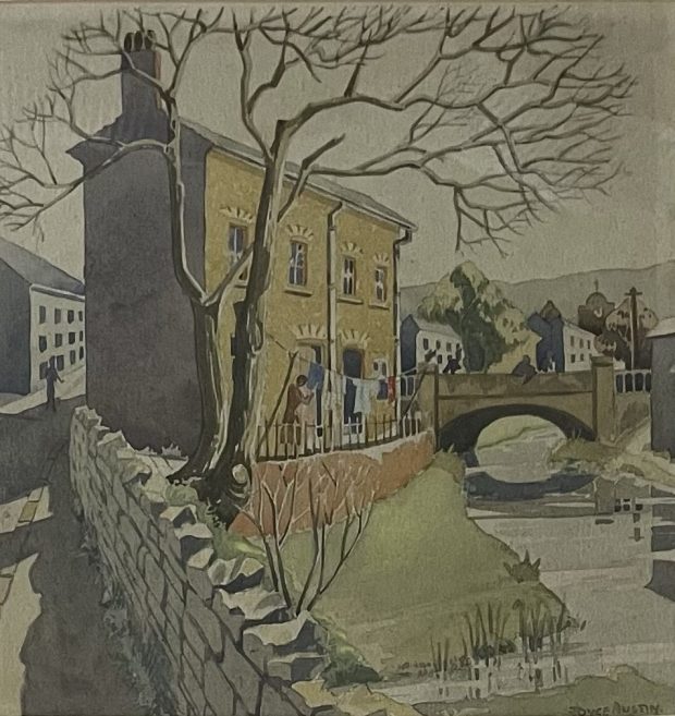Watercolour painting of a pair of tall cottages next to a canal or river with a bare tree and stone wall in the foreground