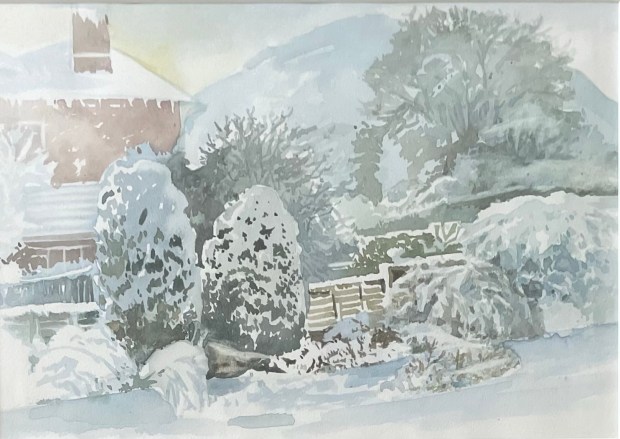 Watercolour of a snowy garden scene showing shrubs and trees covered in snow with a brick building to one side and hillside in the background